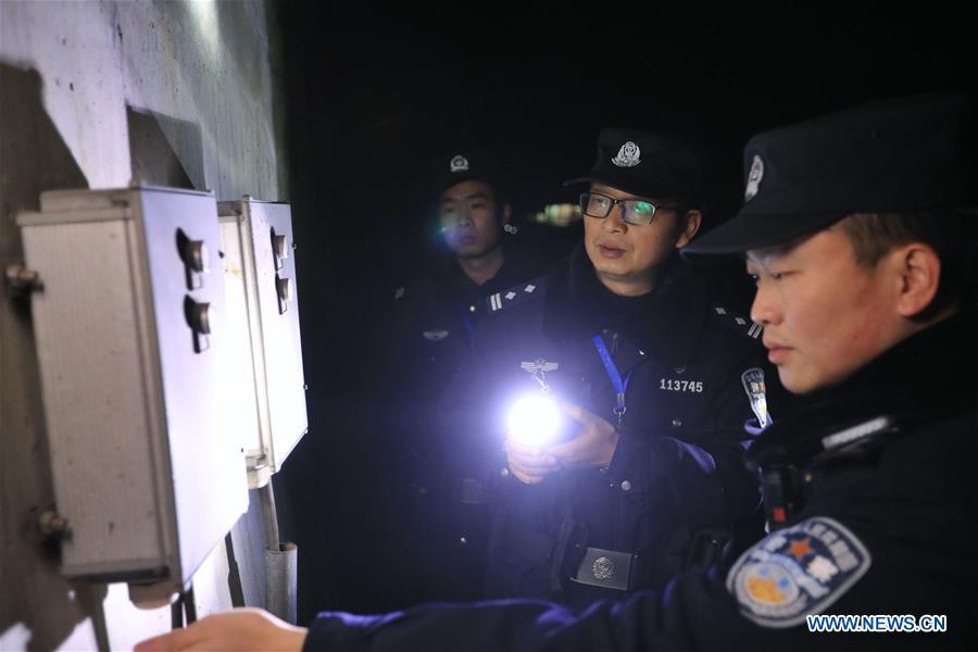 Policemen check the operation of the facilities along the high-speed railway in Rongjiang County, southwest China\'s Guizhou Province, Jan. 22, 2019. Rongjiang Railway Police Station conducts two or three safety inspections at night every week during the Spring Festival travel rush. (Xinhua/Ou Dongqu)