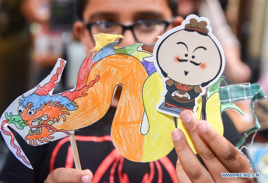 A 7-year-old boy Liam showcases a Chinese dragon and a cartoon figure of terracotta warrior in Te Papa, the national museum of New Zealand in Wellington, New Zealand, Jan. 23, 2019. A family event, with a theme on \