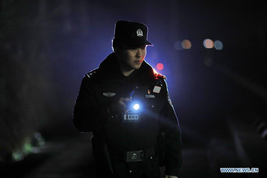 A policeman patrols the high-speed railway in Rongjiang County, southwest China\'s Guizhou Province, Jan. 22, 2019. Rongjiang Railway Police Station conducts two or three safety inspections at night every week during the Spring Festival travel rush. (Xinhua/Ou Dongqu)