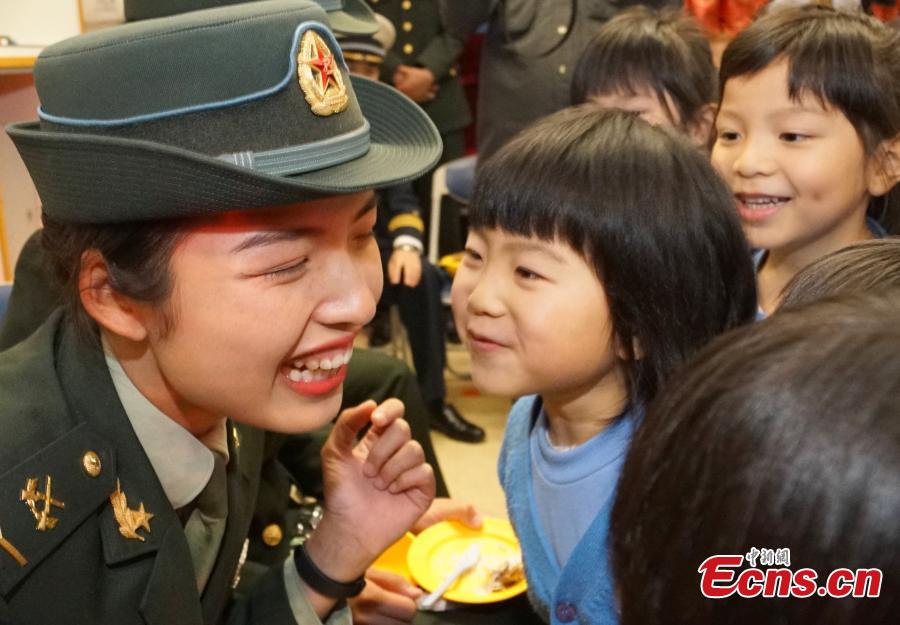 Members of the PLA troops stationed in Hong Kong play games with children at Ka Fuk Baptist Church Pre-School to celebrate the upcoming Spring Festival, China\'s Lunar New Year, in Hong Kong, Jan. 24, 2019. (Photo: China News Service/Zhang Wei)