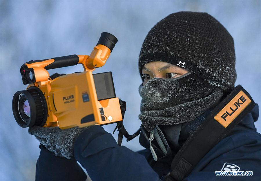 Researcher Yang Tao collects data of snow cover in Sa\'erwuzike Village in Kaxajar township of Zhaosu County, northwest China\'s Xinjiang Uygur Autonomous Region, Jan. 18, 2019. A nine-member research team with an average age under 30 from the Xinjiang Institute of Ecology and Geography under the Chinese Academy of Sciences started a research on snow cover on the Tianshan Mountains in Xinjiang. Snow cover on the Tianshan Mountains is an important source of water resources. Snowmelt provides an abundant water supply for river flow in this area and also affects the ecological system of agricultural and animal husbandry production in the downstream oasis. (Xinhua/Hu Huhu)
