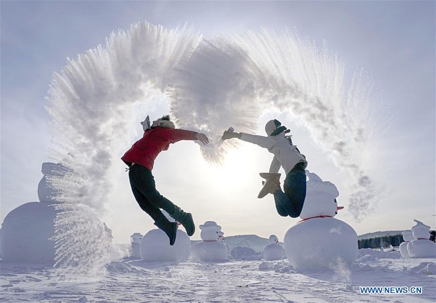 A visitor plays a game with water spray in Beiji Village, Mohe City of northeast China\'s Heilongjiang Province, Jan. 24, 2019. With the lowest temperature approaching minus 30 degrees celsius, visitors in Mohe Village experienced the game of \