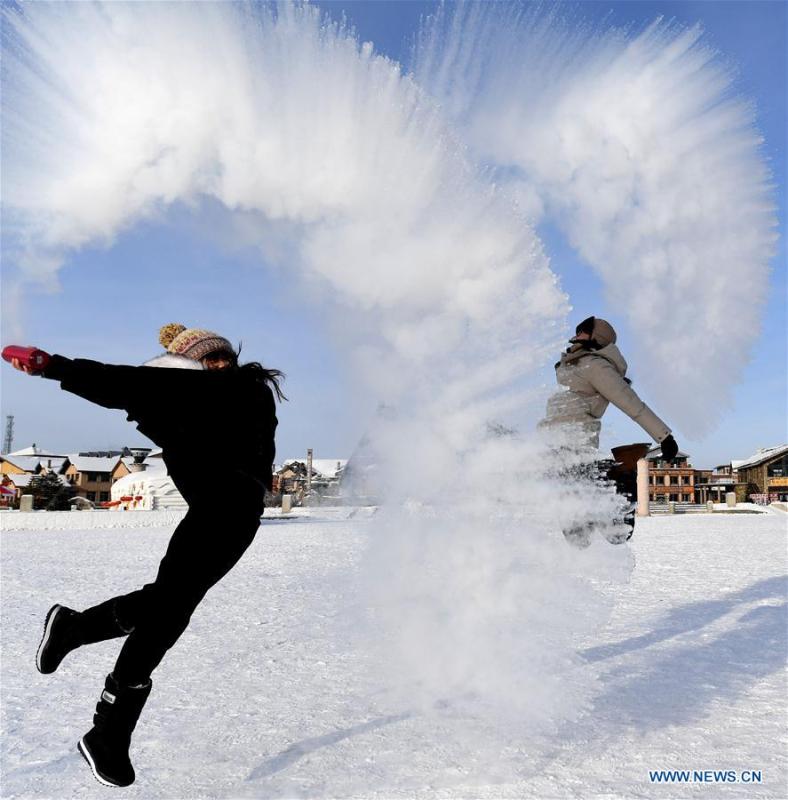 Visitors play a game with water spray in Beiji Village, Mohe City of northeast China\'s Heilongjiang Province, Jan. 24, 2019. With the lowest temperature approaching minus 30 degrees celsius, visitors in Mohe Village experienced the game of \