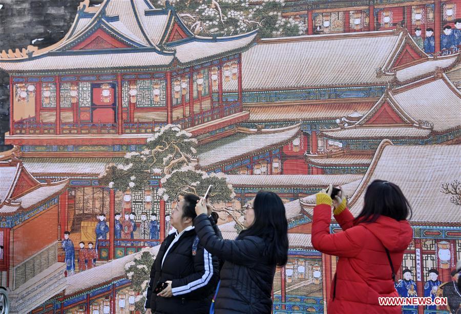 Tourists take photos of paintings in the Palace Museum, also known as the Forbidden City, in Beijing, capital of China, Jan. 25, 2019. The Palace Museum is decorated to celebrate the upcoming Spring Festival, or the Chinese Lunar New Year, which falls on Feb. 5 this year. (Xinhua/Li Xin)