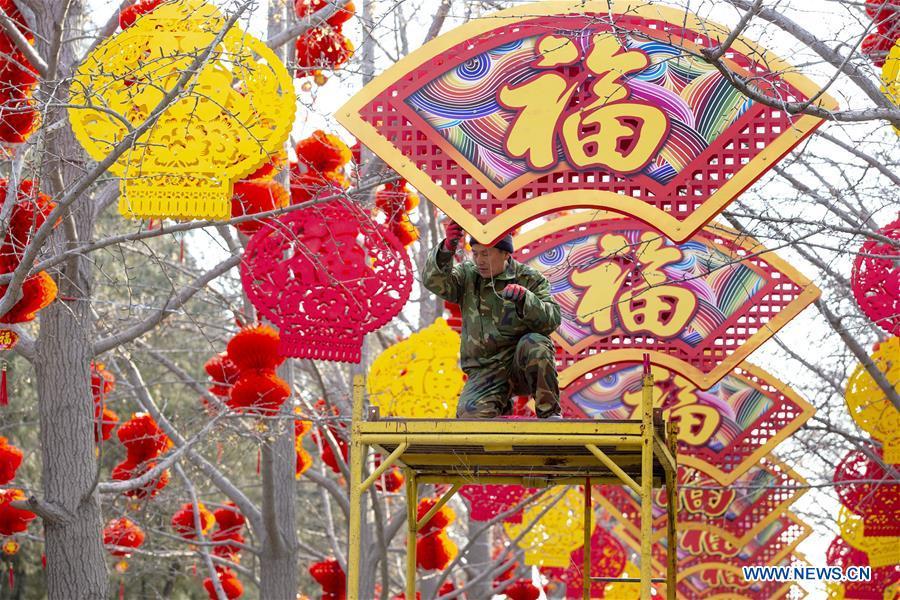 A worker settles decorations for the Spring Festival at the Ditan Park in Beijing, capital of China, Jan. 26, 2019. Red decorations are arranged across China to greet the upcoming lunar New Year which will fall on Feb. 5 this year. (Xinhua)