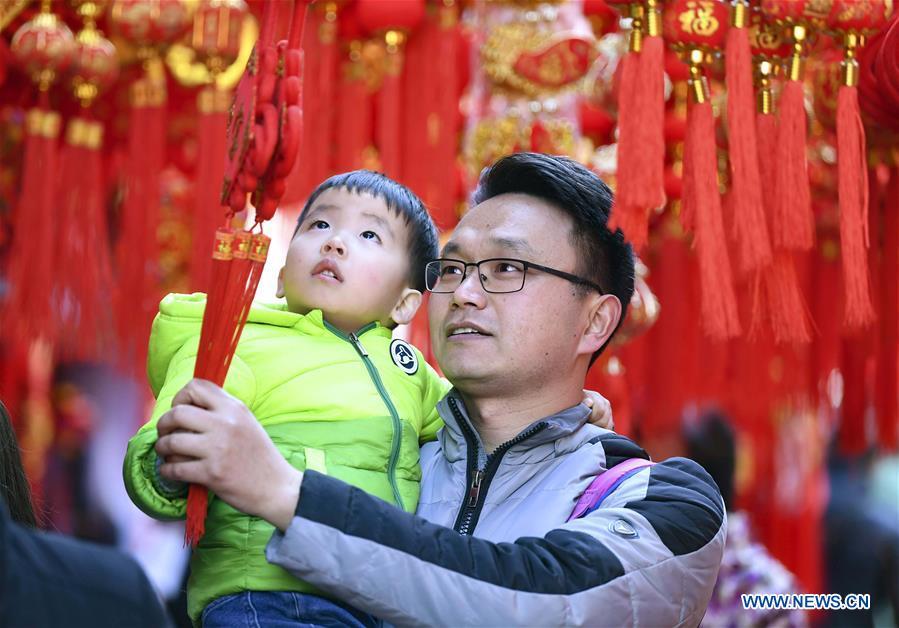 Citizens select Spring Festival goods at a market in Hefei, capital of east China\'s Anhui Province, Jan. 26, 2019. Red decorations are arranged across China to greet the upcoming lunar New Year which will fall on Feb. 5 this year. (Xinhua/Liu Qinli)