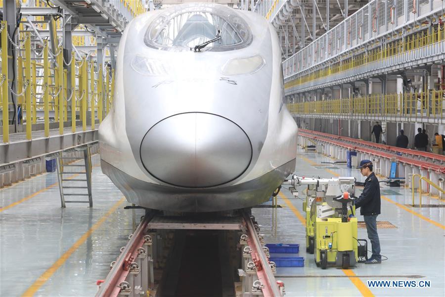 Zhang Yuqi conducts a ultrasound check on a bullet train at a maintenance center in Guiyang, capital of southwest China\'s Guizhou Province, Jan. 30, 2019. As a model train hobbyist, 27-year-old Zhang Yuqi has made and collected more than a hundred model trains. Zhang is also a bullet train mechanic responsible for checking bullet trains during the Spring Festival travel rush at a maintenance center in Guiyang of Guizhou Province. Despite heavy work load and work pressure, Zhang said he is dedicated to ensuring the safety of bullet trains. (Xinhua/Ou Dongqu)