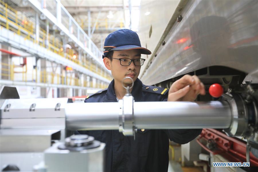 Zhang Yuqi conducts a ultrasound check on a bullet train at a maintenance center in Guiyang, capital of southwest China\'s Guizhou Province, Jan. 30, 2019. As a model train hobbyist, 27-year-old Zhang Yuqi has made and collected more than a hundred model trains. Zhang is also a bullet train mechanic responsible for checking bullet trains during the Spring Festival travel rush at a maintenance center in Guiyang of Guizhou Province. Despite heavy work load and work pressure, Zhang said he is dedicated to ensuring the safety of bullet trains. (Xinhua/Ou Dongqu)
