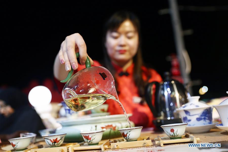 An artist from north China\'s Shanxi Province performs tea art at a temple fair celebrating the Chinese Spring Festival in Sharm el-Sheikh, Egypt, Jan. 30, 2019. The Egyptian tourism city of Sharm el-Sheikh embraced a large festivity where hundreds of rejoiced Egyptians and Chinese celebrated the Chinese Spring Festival together. The event hosted by the Chinese Embassy in Egypt kicked off Wednesday and will run through Friday. (Xinhua/Ahmed Gomaa)
