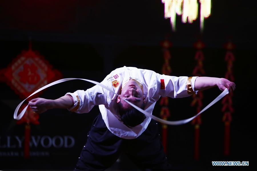 An artist from north China\'s Shanxi Province performs noodle-making skills at a temple fair celebrating the Chinese Spring Festival in Sharm el-Sheikh, Egypt, Jan. 30, 2019. The Egyptian tourism city of Sharm el-Sheikh embraced a large festivity where hundreds of rejoiced Egyptians and Chinese celebrated the Chinese Spring Festival together. The event hosted by the Chinese Embassy in Egypt kicked off Wednesday and will run through Friday. (Xinhua/Ahmed Gomaa)