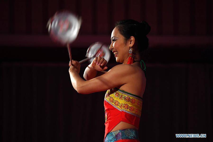 An artist performs acrobatics during a gala held by Confucius Institute Bonn and China Institute of Minority Nationality Dance to celebrate the upcoming Spring Festival, or the Chinese Lunar New Year, in Bonn, Germany, on Jan. 31, 2019. (Xinhua/Lu Yang)