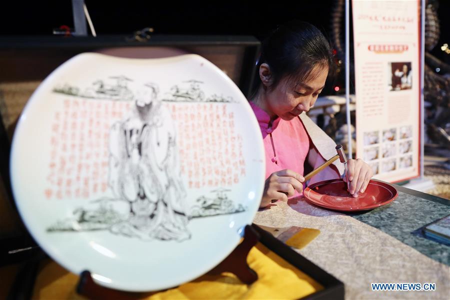 An artist from north China\'s Shanxi Province displays porcelain carving skills at a temple fair celebrating the Chinese Spring Festival in Sharm el-Sheikh, Egypt, Jan. 30, 2019. The Egyptian tourism city of Sharm el-Sheikh embraced a large festivity where hundreds of rejoiced Egyptians and Chinese celebrated the Chinese Spring Festival together. The event hosted by the Chinese Embassy in Egypt kicked off Wednesday and will run through Friday. (Xinhua/Ahmed Gomaa)