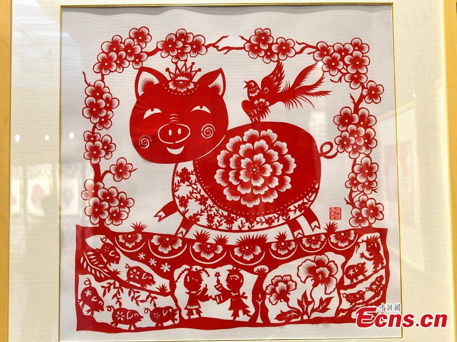 A pig-themed paper-cutting artwork is on display to  celebrate the upcoming Chinese New Year in Fuzhou, Fujian Province, Feb. 1, 2019. The Chinese New Year, or Spring Festival, falls on Feb. 5 this year. The Chinese paper-cutting has a history of more than 1,500 years. It was listed in the UNESCO Intangible Cultural Heritage Lists in 2009. (Photo/China News Service/Lyv Ming)