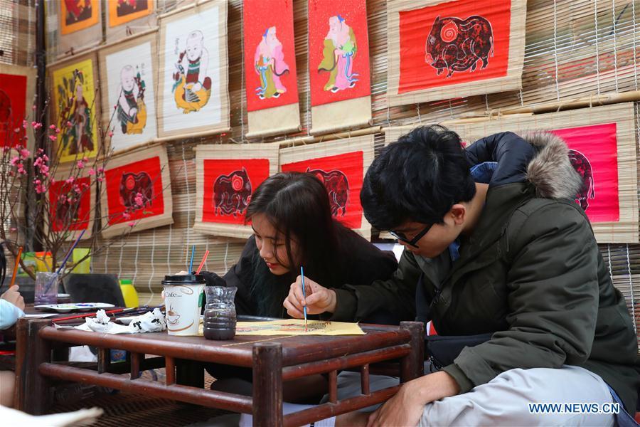 People work on traditional color paintings for the upcoming Lunar New Year in Hanoi, capital of Vietnam, Feb. 1, 2019. The Lunar New Year festival, also called Tet in Vietnamese, is one of the long-standing traditions of Vietnamese people. (Xinhua/Wang Di)
