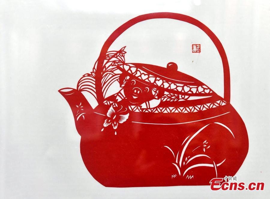 A pig-themed paper-cutting artwork is on display to  celebrate the upcoming Chinese New Year in Fuzhou, Fujian Province, Feb. 1, 2019. The Chinese New Year, or Spring Festival, falls on Feb. 5 this year. The Chinese paper-cutting has a history of more than 1,500 years. It was listed in the UNESCO Intangible Cultural Heritage Lists in 2009. (Photo/China News Service/Lyv Ming)