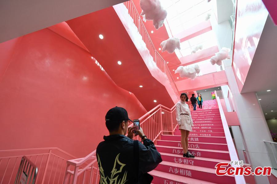 People take photos on pink stairs at the exit of Chunrong Street Subway Station in Kunming City, Southwest China’s Yunnan Province. With cotton clouds suspended in the air and cute love quotes written on the stairs, the pink subway station has quickly gained widespread traction among young people. (Photo: China News Service/Ren Dong)