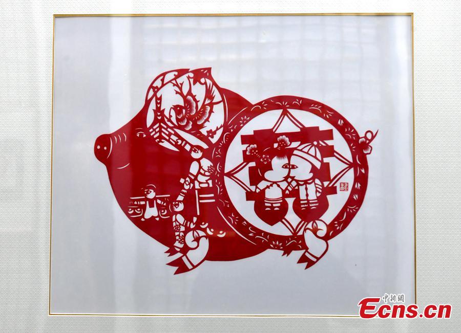 A pig-themed paper-cutting artwork is on display to  celebrate the upcoming Chinese New Year in Fuzhou, Fujian Province, Feb. 1, 2019. The Chinese New Year, or Spring Festival, falls on Feb. 5 this year. The Chinese paper-cutting has a history of more than 1,500 years. It was listed in the UNESCO Intangible Cultural Heritage Lists in 2009. (Photo/China News Service/Lyv Ming)