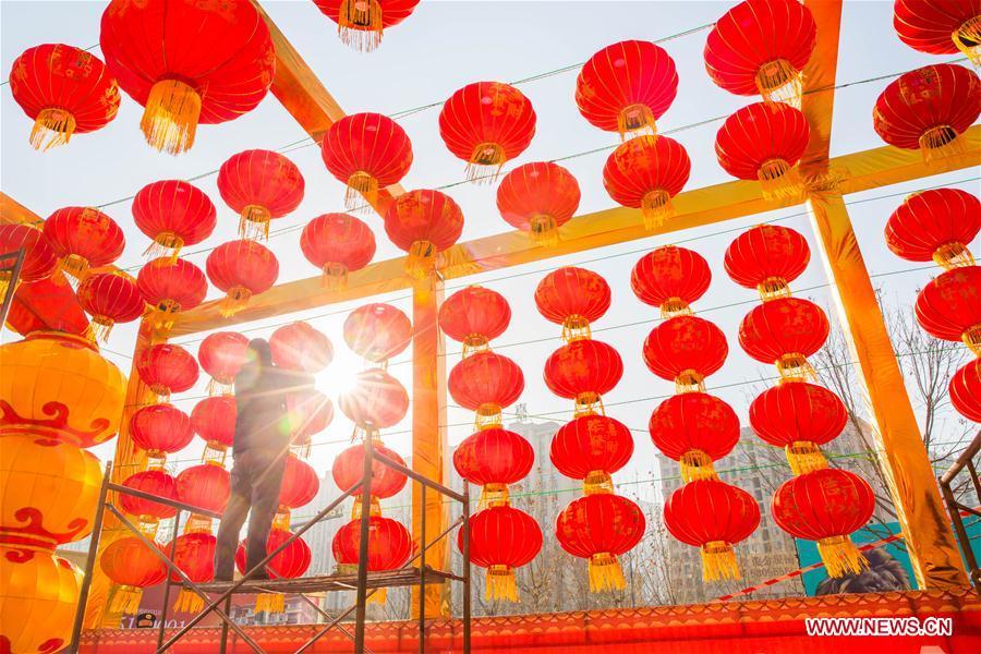 A worker hangs red lanterns for the upcoming Spring Festival at the gate of a shopping mall in Handan City, north China\'s Hebei Province, Feb. 1, 2019. The Spring Festival, or the Chinese Lunar New Year, falls on Feb. 5 this year. (Xinhua/Qiao Hailong)