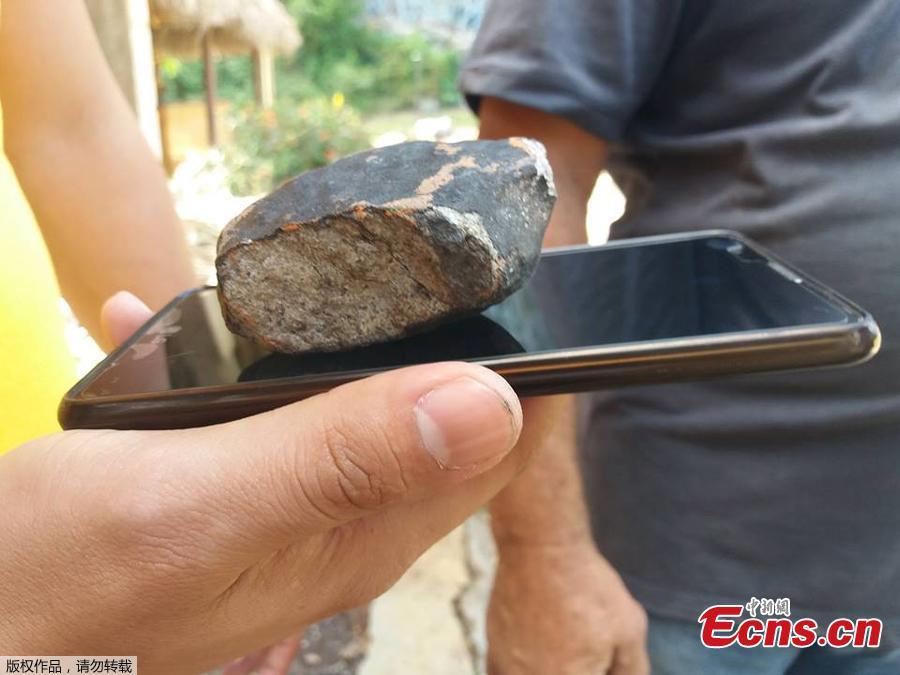 Handout picture released by Tele Pinar showing an alleged piece of a meteorite that fell in Cuba on February 1, 2019, taken in Vinalez, in the Cuban western province of Pinar del Rio. - The fall of a meteorite caused a strong explosion preceded by a flash that shook several municipalities in the Cuban province of Pinar del Rio, according to a member of the state astronomy institute.(Photo/Agencies)