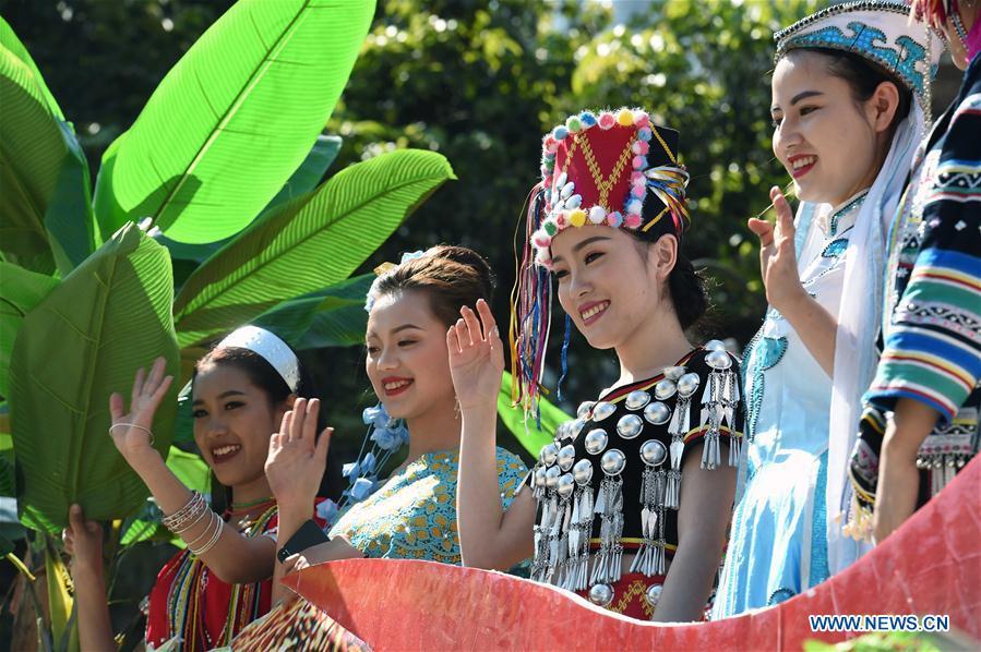Women wave hands during a parade at Lancang Lahu Autonomous County in Pu\'er City, southwest China\'s Yunnan Province, Feb. 7, 2018. People of ethnic groups wearing their traditional festive costumes took part in a parade to celebrate the Chinese Lunar New Year in Lancang Lahu Autonomous County. (Xinhua/Yang Zongyou)