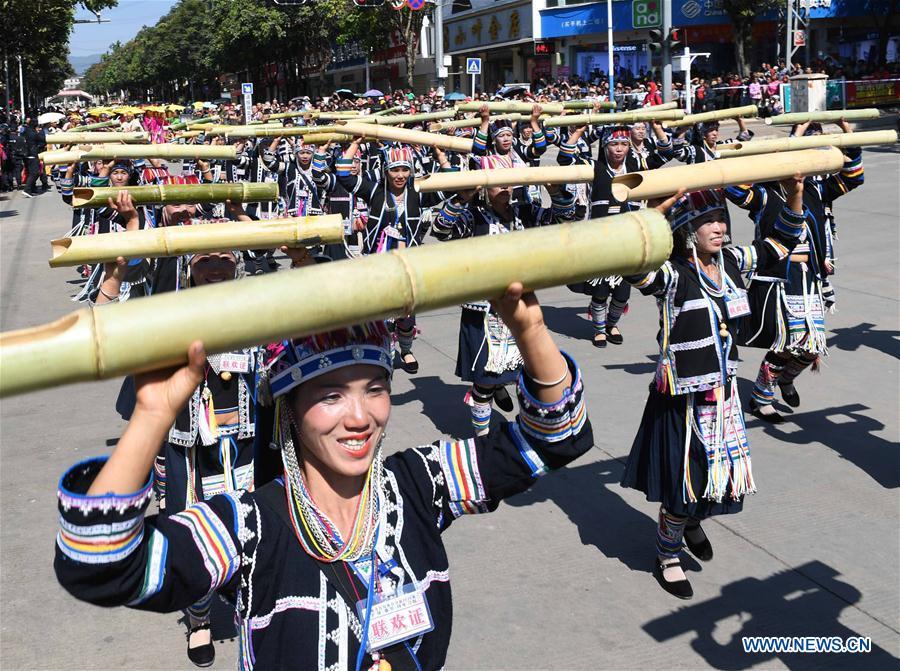 People take part in bamboo pole dance during a parade at Lancang Lahu Autonomous County in Pu\'er City, southwest China\'s Yunnan Province, Feb. 7, 2018. People of ethnic groups wearing their traditional festive costumes took part in a parade to celebrate the Chinese Lunar New Year in Lancang Lahu Autonomous County. (Xinhua/Yang Zongyou)