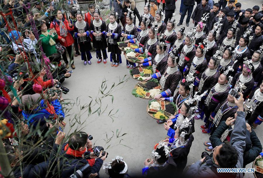 People of Dong ethnic group greet tourists during the Spring Festival holiday in Dingdong Village of Qiandongnan Miao and Dong Autonomous Prefecture, southwest China\'s Guizhou Province, Feb. 8, 2019. (Xinhua/Long Tao)