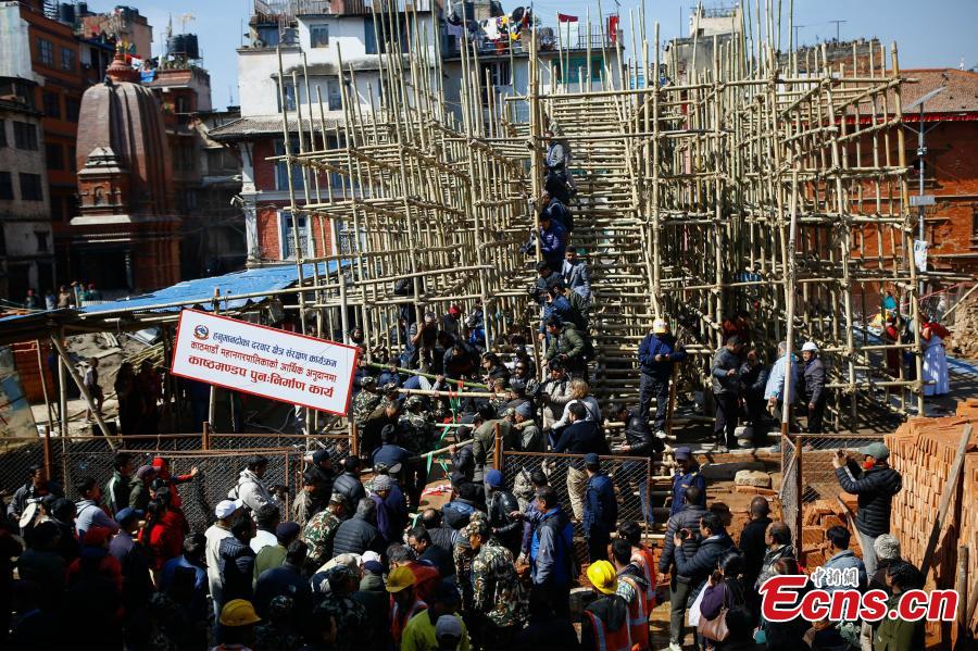People carry wooden pillars for erection at the reconstruction site of the Kasthamandap temple at Hanumandhoka Durbar Square in Kathmandu, Nepal, Feb. 10, 2019. A ceremony was held to keep the wooden pillars to reconstruct the Kasthamandap temple, which was destroyed during the 2015 earthquake. Kasthamandap (Kastha: wood, mandap: pavilion) temple is one of the oldest and historical building in Kathmandu. (Photo: China News Service/Pu Ladan)