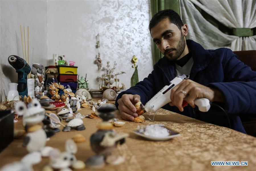 Palestinian young man Ahmed al-Madhoun, 31, makes an art piece with seashells at his house in Gaza City, on Feb. 10, 2019. A Palestinian young man from Gaza turns seashells into beautiful artifacts that adorn his home to satisfy his passion for this type of art. Using seashells he collects from Gaza beaches, 31-year-old Ahmed al-Madhoun makes various art pieces such as animals, birds and some funny characters. Al-Madhoun, who holds a college degree in radio and television engineering and works for a local telecommunication company, has been collecting multiple forms of seashells from the Gaza seashore for more than four years. The young man began the hobby of seashell art about a year and a half ago, and he already made large numbers of art pieces.  (Xinhua/Stringer)