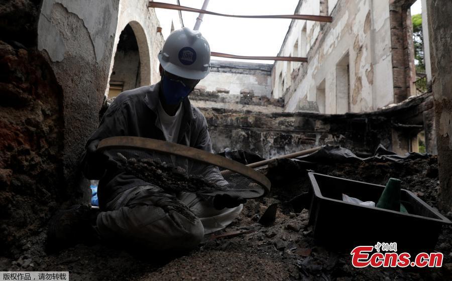 A staffer of Brazil National Museum works on searching and saving artefacts after its devastating fire, in Rio de Janeiro, Brazil, Feb. 12, 2019. Five months after fire gutted Brazil\'s 200-year-old National Museum, the site that once held some of the nation\'s greatest treasures remains a ruin of scorched walls, twisted metal and piles of ash. (Photo/Agencies)