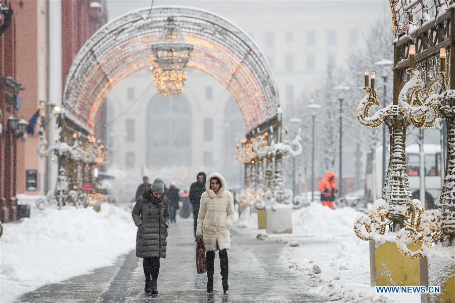 People walk in snow in Moscow, Russia, on Feb. 13. 2019. A recent snowfall resulted in 11 mm of precipitation in Moscow on Wednesday. (Xinhua/Evgeny Sinitsyn)