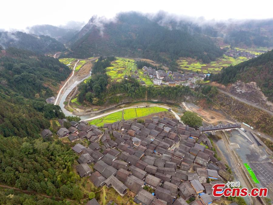 An aerial photo of the picturesque Wugong Dong Village in Rongjiang County, Guizhou Province, Feb. 13, 2019. The village, home to 171 Dong families, has well-preserved old wooden buildings that are now surrounded by cauliflowers in bloom. The village was inscribed as a national traditional village in 2016. (Photo: China News Service/He Junyi)