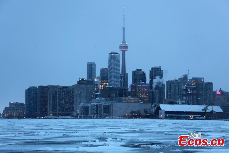 Toronto skyline is seen with floating ice on Lake Ontario in Toronto, Canada, on Feb. 13, 2019. A winter storm of a mix of snow, freezing rain and strong winds hit the Greater Toronto Area from Tuesday to Wednesday. (Photo/China News Service)