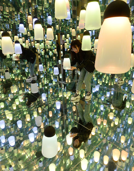 A woman touches a decoration in the 3D immersive pavilion in Handan city, Hebei province, on Feb 14, 2019. (Photo by Hao Qunying/Asianewsphoto)