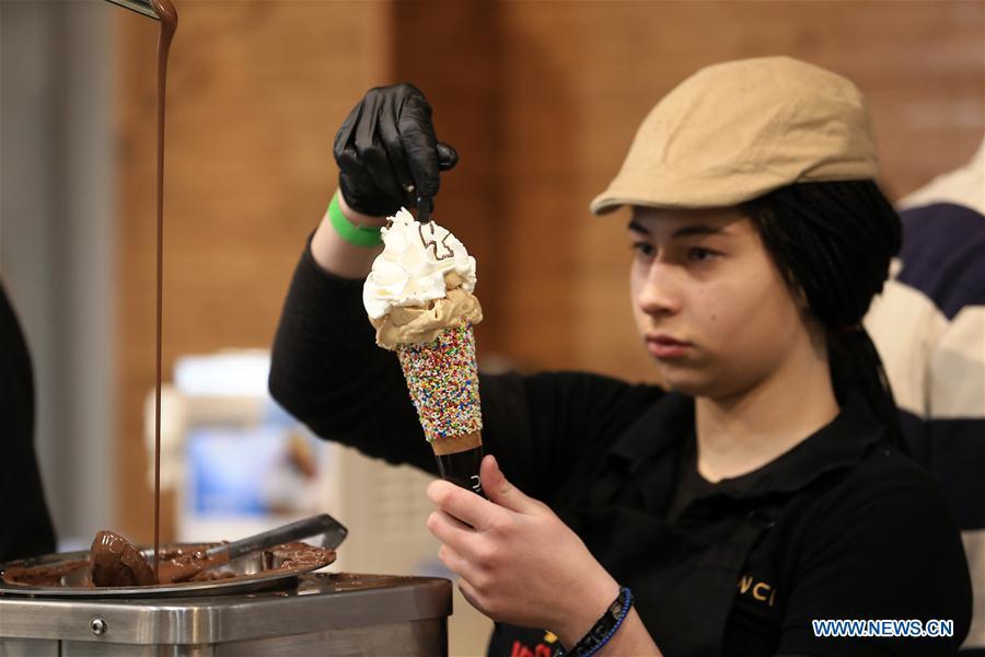 A worker makes an ice cream during the Chocolate Festival in Athens, Greece, Feb. 16, 2019. The four-day festival, held from February 14 to 17, involved tasting sessions, workshops and children activities led by experts dedicated to the art of chocolate. (Xinhua/Marios Lolos)