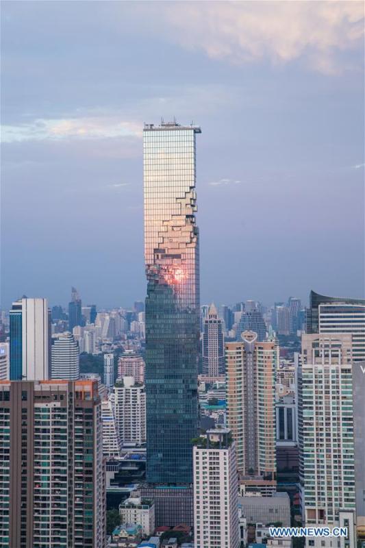 The photo shows King Power MahaNakhon skyscraper in sunset after rainfall in Bangkok, Thailand, Feb. 17, 2019. The rainfall helped to improve the air quality in Bangkok. (Xinhua/Zhang Keren)