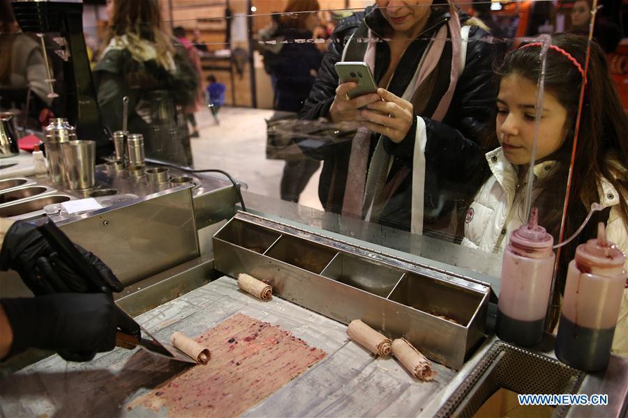 Visitors watch the making of chocolate sweets during the Chocolate Festival in Athens, Greece, Feb. 16, 2019. The four-day festival, held from February 14 to 17, involved tasting sessions, workshops and children activities led by experts dedicated to the art of chocolate. (Xinhua/Marios Lolos)