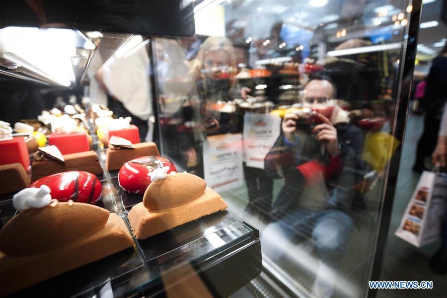 A man takes photos of handmade confectionery at the Expo Sweet in Warsaw, Poland, on Feb. 17, 2019. Expo Sweet, one of the largest confectionery and ice-cream fairs in Poland, is held in Warsaw from Feb. 17 to 20. (Xinhua/Jaap Arriens)