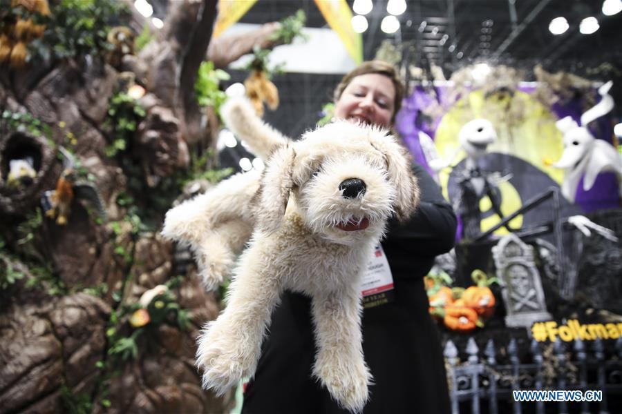 A sales person shows a stuffed toy at the 116th Annual North American International Toy Fair at the Jacob K. Javits Convention Center in New York, the United States, Feb. 16, 2019. The toy fair, held from February 16 to 19 this year, gathered more than 1,000 toy exhibitors and hundreds of thousands of toys and youth entertainment products to retail outlets and trade guests from over 100 countries and regions. (Xinhua/Wang Ying)