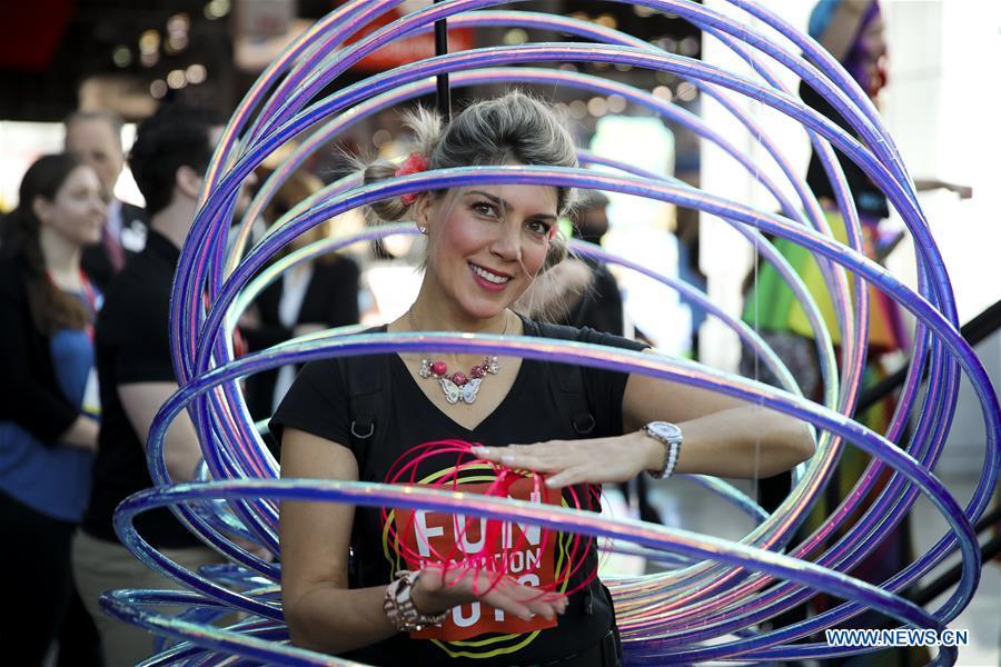 A sales person shows toy products at the 116th Annual North American International Toy Fair at the Jacob K. Javits Convention Center in New York, the United States, Feb. 16, 2019. The toy fair, held from February 16 to 19 this year, gathered more than 1,000 toy exhibitors and hundreds of thousands of toys and youth entertainment products to retail outlets and trade guests from over 100 countries and regions. (Xinhua/Wang Ying)