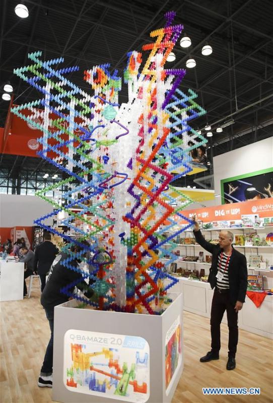Exhibitor representatives demonstrate a marbel maze game at the 116th Annual North American International Toy Fair at the Jacob K. Javits Convention Center in New York, the United States, Feb. 16, 2019. The toy fair, held from February 16 to 19 this year, gathered more than 1,000 toy exhibitors and hundreds of thousands of toys and youth entertainment products to retail outlets and trade guests from over 100 countries and regions. (Xinhua/Wang Ying)