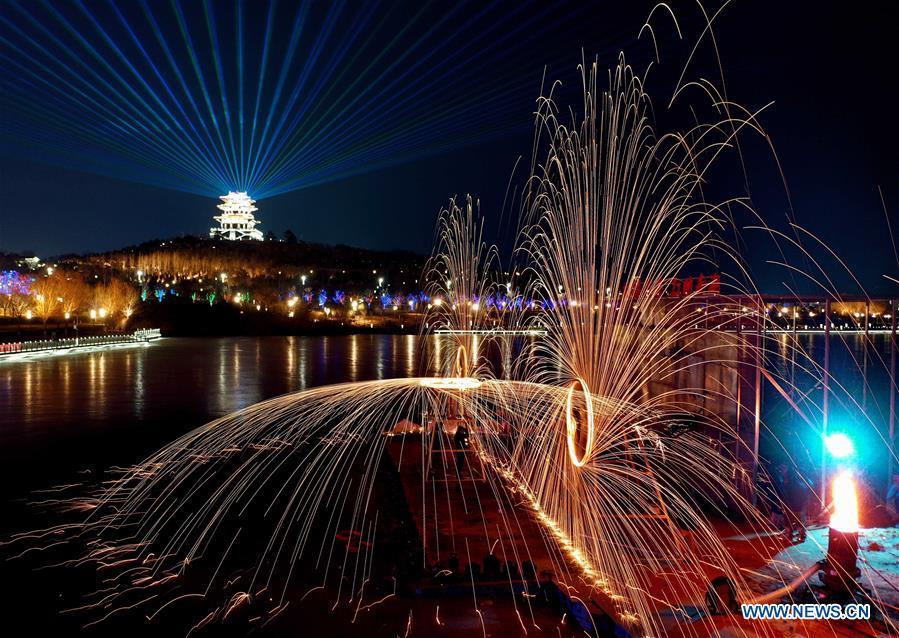 Aerial photo shows folk artists spraying molten iron at a lantern fair in the Nanhu Park in Tangshan, north China\'s Hebei Province, Feb. 15, 2019. (Xinhua/Yang Shiyao)