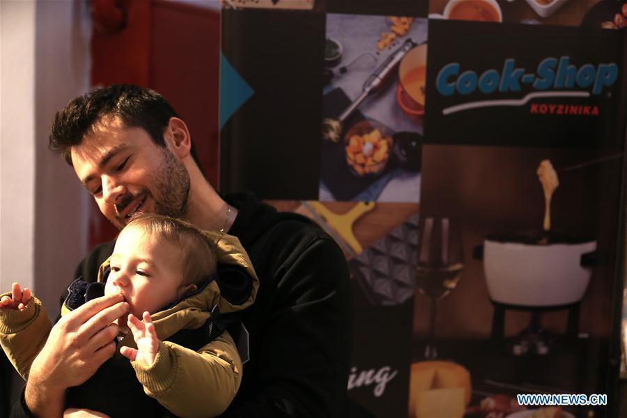 A young visitor tastes chocolate during the Chocolate Festival in Athens, Greece, Feb. 16, 2019. The four-day festival, held from February 14 to 17, involved tasting sessions, workshops and children activities led by experts dedicated to the art of chocolate. (Xinhua/Marios Lolos)