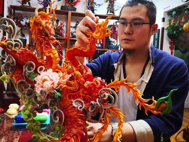 Gong Yuze works on an intricate dough figurine in his studio in Harbin, capital of Northeast China\'s Heilongjiang Province. (Photo by Zhang Qingyun for chinadaily.com.cn)
Thirty-year-old Gong Yuze has been obsessed with flour dough for more than a decade. But instead of turning it into dumplings or pancakes, the high school dropout has created a lucrative business by turning the dough into vivid figurines from Chinese folk culture.

A set of four figurines can sell for 12,000 yuan ($1,770) at his studio in Harbin, Northeast China\'s Heilongjiang Province. The average price of a dough figurine starts at about 10 yuan.

The native of a small town on the outskirts of Harbin was intrigued by the Chinese traditional craft in 2006, when he was working at a variety of side gigs in Tianjin. Although his attempt to make a copy of an original piece he bought from the local craftsman failed, it only inspired him to further invest more of his time and effort to learn the required skills.

Over the years, the self-taught sculptor has made and sold nearly 10,000 dough figurines and even developed a new sculpting material by changing the proportion of flour used in the dough so that the figurines have a longer shelf life.

Financial gains aside, the young man said his biggest sense of achievement today comes from carrying on the traditional crafts and perfecting them.