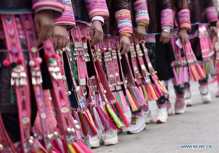 People of the Miao ethnic group dance to the Lusheng, a reed-pipe wind instrument, to celebrate their new life at the relocated Fengle community in Rongjiang County, southwest China\'s Guizhou Province, Feb. 21, 2019. The relocated ethnic Miao people from remote areas to the community held a gathering Thursday by inviting neighboring Miao villages\' Lusheng teams to celebrate their new life. (Xinhua/Jiang Zuoxian)