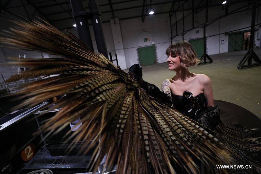 A model makes a video phone call backstage during the opening show of the 6th Brussels Chocolate Salon in Brussels, Belgium, Feb. 21, 2019. The 6th Brussels Chocolate Salon (Salon du Chocolat Brussels) kicked off here on Thursday. In the following three days, 130 chocolatiers, pastry chefs, confectioners, designers and cocoa experts of international reputation in attendance will share and exhibit chocolate in all its delectable forms. (Xinhua/Zheng Huansong)
