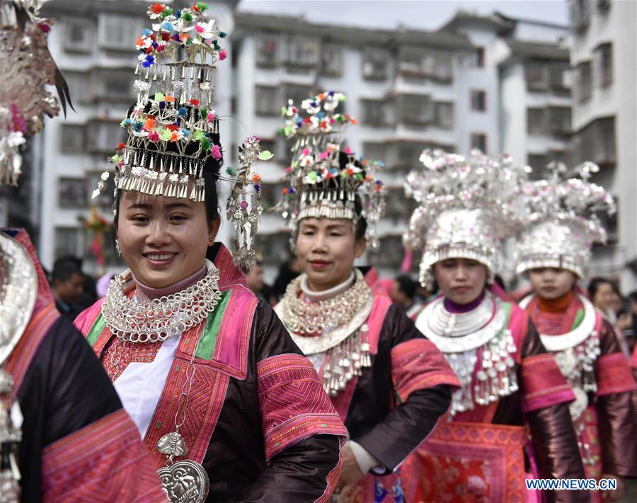 People of the Miao ethnic group dance to the Lusheng, a reed-pipe wind instrument, to celebrate their new life at the relocated Fengle community in Rongjiang County, southwest China\'s Guizhou Province, Feb. 21, 2019. The relocated ethnic Miao people from remote areas to the community held a gathering Thursday by inviting neighboring Miao villages\' Lusheng teams to celebrate their new life.(Xinhua/Jiang Zuoxian)