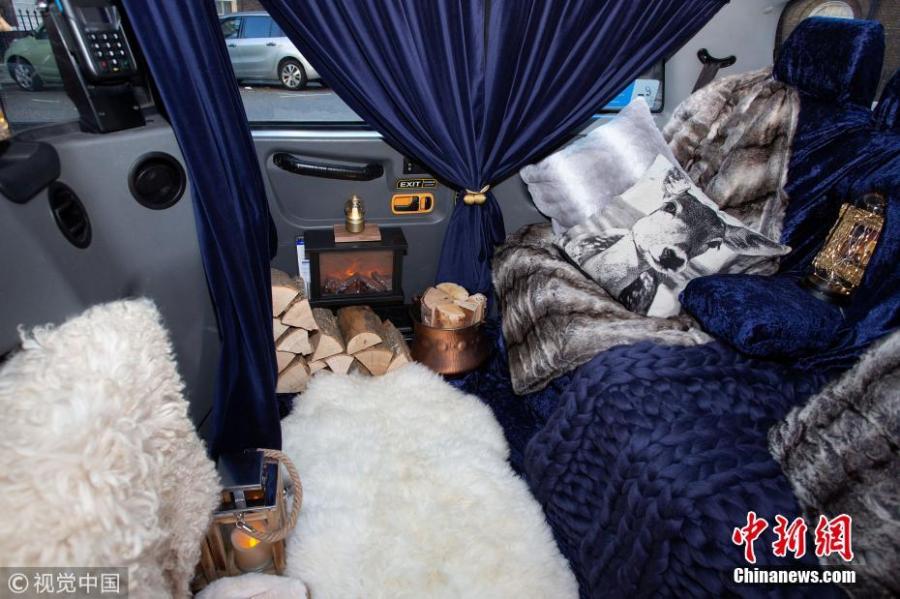 The world’s cosiest taxi has been unveiled in London featuring velvet seats, sheepskin rugs -- and a roaring fireplace. The one-of-a kind taxi has been decked out to resemble a country log cabin. Passengers in the cab will even be given a pair of sheepskin slippers. The mobile log cabin is currently being trialed and will be picking up commuters from all across the city for free. (Photo/VCG)