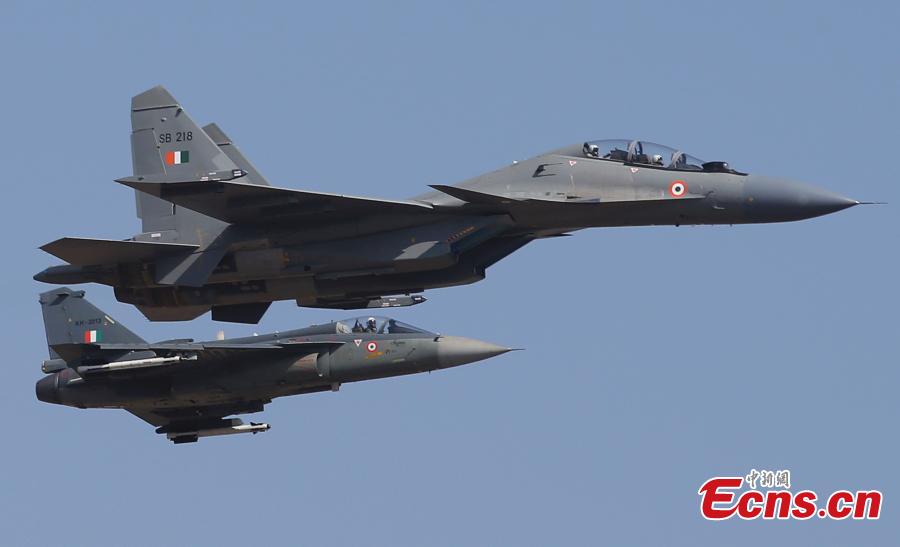 Indian Air Force fighter aircrafts Sukhoi Su-30 MKI flies over Tejas performing aerobatic maneuvers on the inaugural day of Aero India 2019 at Yelahanka air base in Bangalore, India, Feb. 20, 2019. Over 400 exhibitors from more than 20 countries and regions are participating in Aero India show this year. (Photo/Agencies)