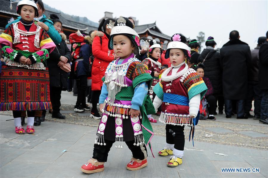 Kids in traditional costumes perform the lusheng dance in Zhouxi Town, Kaili City of southwest China\'s Guizhou Province, Feb. 24, 2019. The ethnic Miao girls donning traditional embroidered attire and silver ornaments sing and dance to the sound of the lusheng, a reed-pipe wind instrument, to pray for a good harvest. Ethnic Miao people get together at Gannangxiang to rejoice in the annual Gannangxiang celebration, one of the largest-scale and most primitive Miao lusheng celebrations in Guizhou Province. (Xinhua/Yang Wenbin)