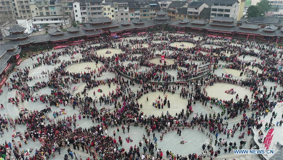 Aerial photo taken on Feb. 24, 2019 shows people of the Miao ethnic group performing the lusheng dance in Zhouxi Town, Kaili City of southwest China\'s Guizhou Province. The ethnic Miao girls donning traditional embroidered attire and silver ornaments sing and dance to the sound of the lusheng, a reed-pipe wind instrument, to pray for a good harvest. Ethnic Miao people get together at Gannangxiang to rejoice in the annual Gannangxiang celebration, one of the largest-scale and most primitive Miao lusheng celebrations in Guizhou Province. (Xinhua/Yang Wenbin)